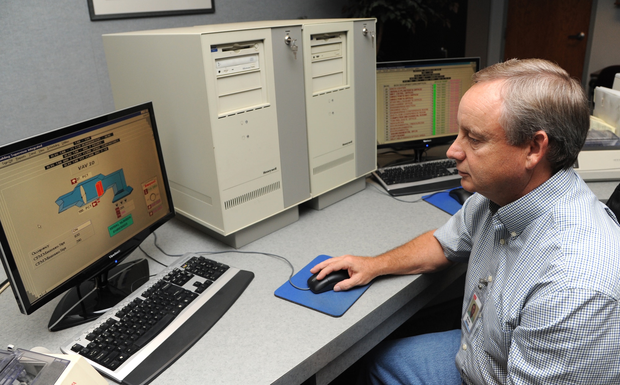 Byron Gainer monitors energy usage in one of 75 buildings at Vance Air Force Base, Okla., that are connected to the Energy Management Control System. Gainer, an EMCS network analyst, helps save the base $217,000 in energy costs annually. (U.S. Air Force photo/ Airman 1st Class Frank Casciotta)