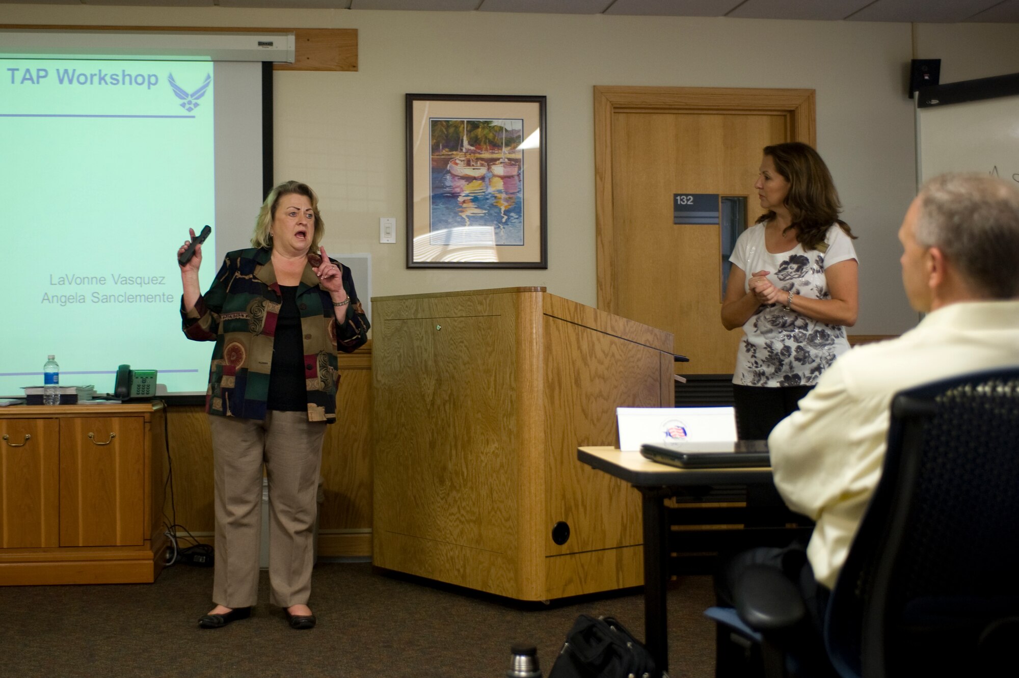 LaVonne Vasquez (left) and Angela Sanclemente, community readiness consultants at the Family and Readiness Center, introduce themselves as facilitators of the Transition Assistance Program at the beginning of the day.  The two women have more than 30 years of transition assistance experience between them.  (U.S. Air Force photo / Airman 1st Class Benjamin D. Kim)
