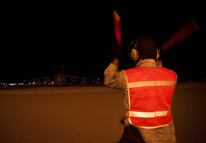 Staff Sgt. Lance Griffin, 305th Air Mobility Wing maintainer from Joint Base McGuire-Dix-Lakehurst, N.J., marshalls the aircraft forward as it departs from Base Charleston to return to JB MDL to assist with Hurricane Sandy relief efforts Oct. 31, 2012. C-17 Globemaster IIIs from JB MDL and Dover Air Force Base, Del., landed here over the weekend because of the intensity of Hurricane Sandy affecting the Northeast. (U.S. Air Force photo/Senior Airman Dennis Sloan)