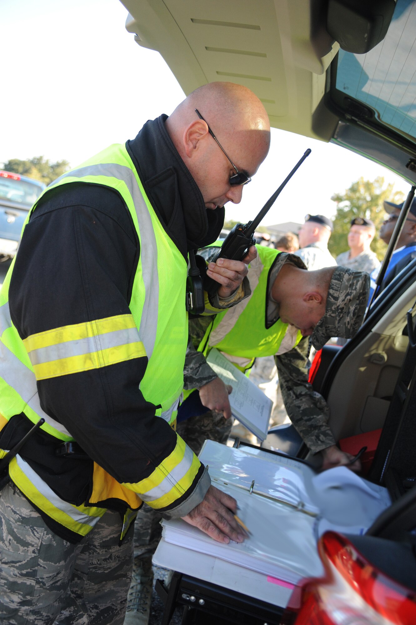Master Sgts. Jerame Bullard and Daniyel Blankenship, Keesler firefighters, document pertinent information into an event log during a hazardous material and major accident response exercise Oct. 31, 2012, at Hangar 4, Keesler Air Force Base, Miss.  The exercise scenario consisted of a group of Airmen cleaning inside the hangar in preparation for demolition when a shelf holding old munitions fell to the ground causing one to break open, explode and splash an “oily substance” on several of the “victims.”  The exercise helped prepare first responders in the event of a real-world incident.  (U.S. Air Force photo by Kemberly Groue)