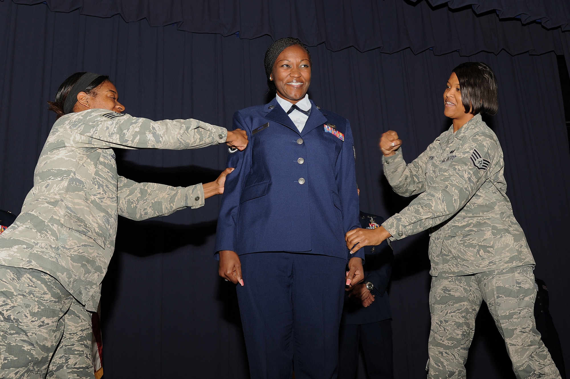 U.S. Air Force Staff Sgt. Kimberly Jones, a career development specialist with 1st Special Operations Force Support Squadron, withstands the punches that mark her transition to staff sergeant during an NCO recognition ceremony at the King Auditorium on Hurlburt Field, Fla., Oct. 30, 2012. Part of the NCO recognition ceremony is the reading of the NCO Charge, which lays out the new responsibilities as staff sergeants. (U.S. Air Force Photo/Airman 1st Class Michelle Vickers)