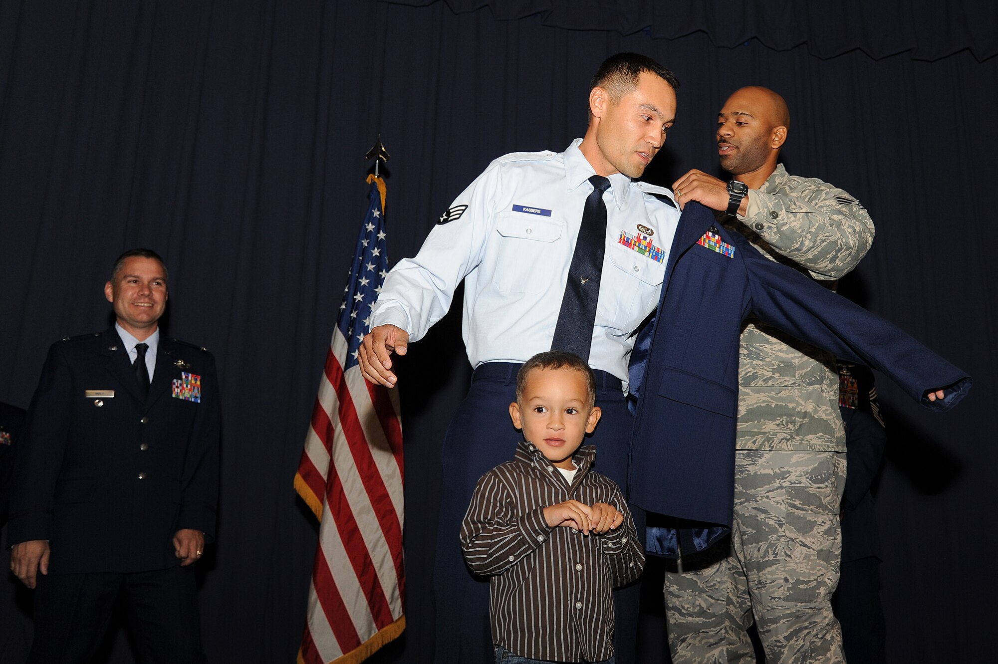 U.S. Air Force Staff Sgt. Eric Kasberg, a services specialist with 1st Special Operations Force Support Squadron, dons his new staff sergeant stripes for the first time during an NCO recognition ceremony at the King Auditorium on Hurlburt Field, Fla., Oct. 30, 2012. Both his co-worker and his son, Riley, punched Kasberg’s new stripes as part of an NCO tradition. (U.S. Air Force Photo/Airman 1st Class Michelle Vickers)
