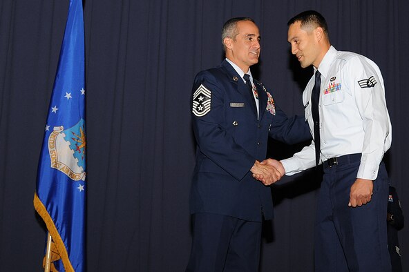 U.S. Air Force Staff Sgt. Eric Kasberg, a services specialist with 1st Special Operations Force Support Squadron, receives congratulations from Chief Master Sgt. Ramon Colon-Lopez, command chief of 1st Special Operations Wing, on his promotion during an NCO recognition ceremony at the King Auditorium on Hurlburt Field, Fla., Oct. 30, 2012. The ceremony marks a rite of passage welcoming enlisted Airmen to the NCO tier. (U.S. Air Force Photo/Airman 1st Class Michelle Vickers)