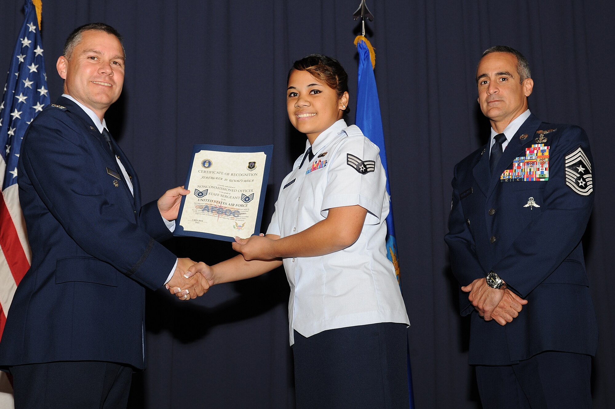 U.S. Air Force Staff Sgt. Fiatagata Ulukivaiola, a formal training technician with 1st Special Operations Force Support Squadron, accepts her promotion certificate from Col. William Holt, vice commander of 1st Special Operations Wing, during an NCO recognition ceremony at the King Auditorium on Hurlburt Field, Fla., Oct. 30, 2012. Holt emphasized the importance of increased responsibilities, including Airmen taking care of each other. (U.S. Air Force Photo/Airman 1st Class Michelle Vickers)
