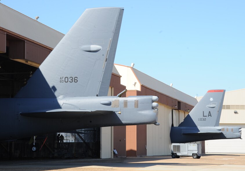 Two B-52H Stratofortress bombers stick out of a hanger on Barksdale Air Force Base, La., Oct. 31. The B-52 provides the backbone of the bomber force with the ability for global attack and precision engagement. The bomber is capable of flying at high subsonic speeds at altitudes up to 50,000 feet. (U.S. Air Force photo/Senior Airman Sean Martin)(RELEASED)