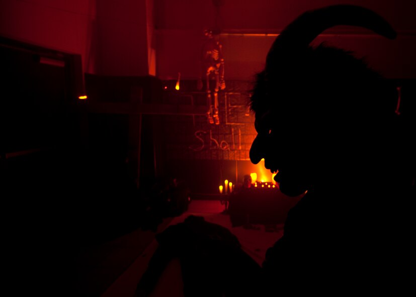 Staff Sgt. Daniel Green, 7th Mission Operations Squadron, dressed as a devil, waits for “victims” Oct. 26, 2012, during the 7th MUNS Haunted House at Dyess Air Force Base, Texas. The haunted house was part of the Fall Carnival held at the Dyess Youth Center, which had games, food and a costume contest. Proceeds from the haunted house went to the youth center. (U.S. Air Force photo by Airman 1st Class Damon Kasberg/ Released)