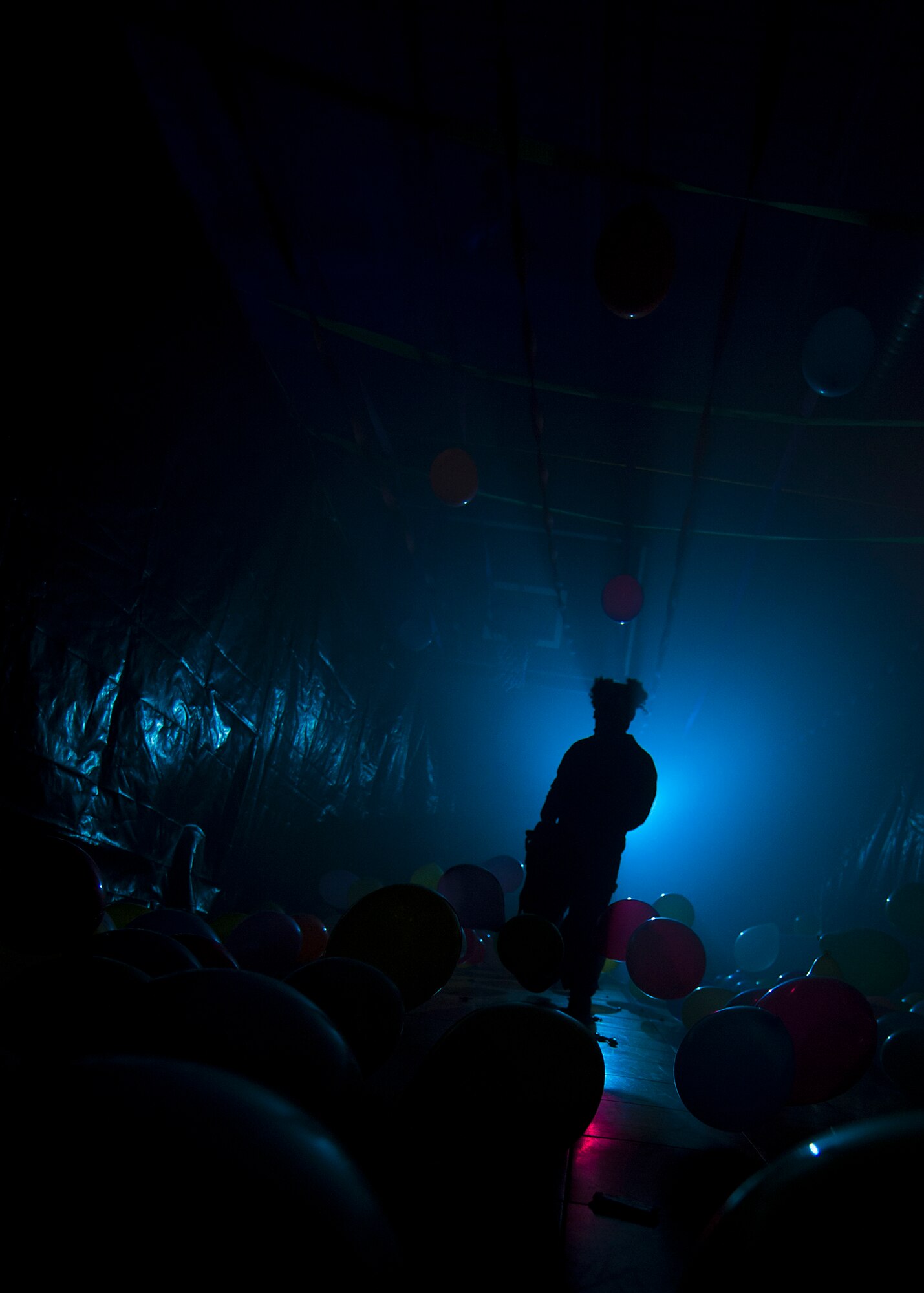 Master Sgt. Ricardo Vela, 7th Munitions Squadron, dressed as a clown with a chainsaw, wanders the haunted party room looking for “victims” Oct. 26, 2012, during the 7th MUNS Haunted House at Dyess Air Force Base, Texas. The haunted house was part of the Fall Carnival held at the Dyess Youth Center, which had games, food and a costume contest. Proceeds from the haunted house went to the youth center. (U.S. Air Force photo by Airman 1st Class Damon Kasberg/ Released)