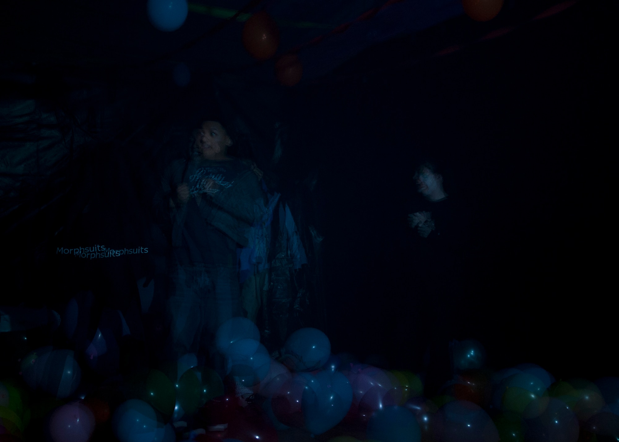 A 7th Munitions Squadron Haunted House visitor makes his way through the party room Oct. 26, 2012, at Dyess Air Force Base, Texas. The haunted house was part of the Fall Carnival held at the Dyess Youth Center, which had games, food and a costume contest. Proceeds from the haunted house went to the youth center. (U.S. Air Force photo by Airman 1st Class Damon Kasberg/ Released)