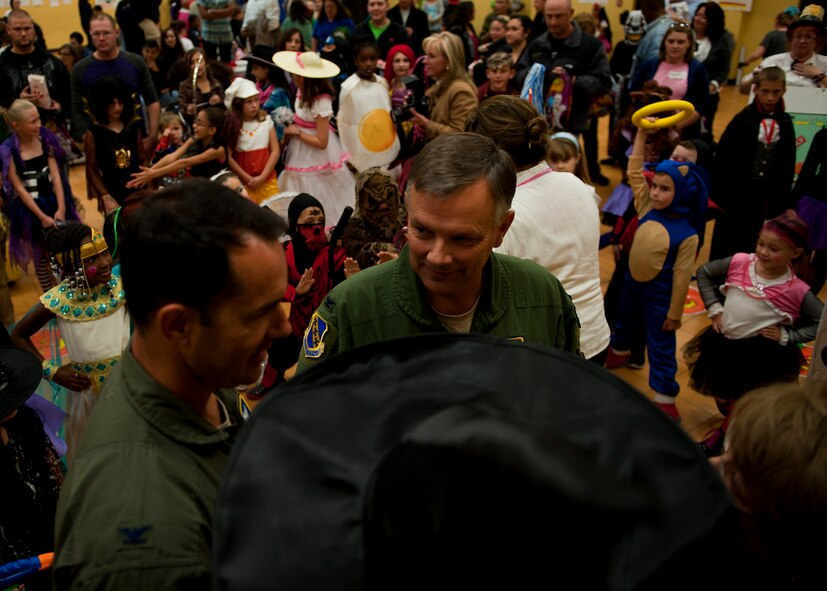 Col. Glen VanHerck, 7th Bomb Wing commander, discusses with fellow judges his opinion on who he thinks the winners of the costume contest should be Oct. 26, 2012, during the Fall Carnival at Dyess Air Force Base, Texas. The carnival had food, games and a haunted house for people to enjoy. (U.S. Air Force photo by Airman 1st Class Damon Kasberg/ Released)