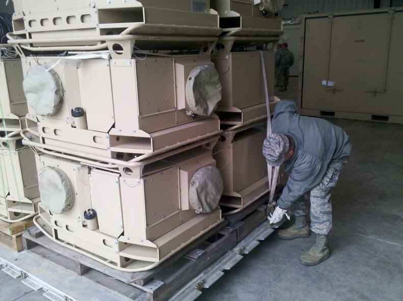 Charlotte, N.C. (10/31/12) North Carolina Air National Guard’s 145th Civil Engineer Squadron  called 26 Airmen to active duty at the Stanly County Airport near Albemarle, N.C. These guardsmen will ready the Disaster Relief Beddown System , a self-contained package designed to support 500 people with tents, generators, showers and bathroom facilities.   Here airmen from 145th CES prepare a 60 kilowatt generator, palletize heaters and prepare a Reverse Osmosis Water Purification Unit for air transportation.  (National Guard photo by Lt. Col. Timothy Moran, Deputy Commander, 145th Civil Engineer Squadron)