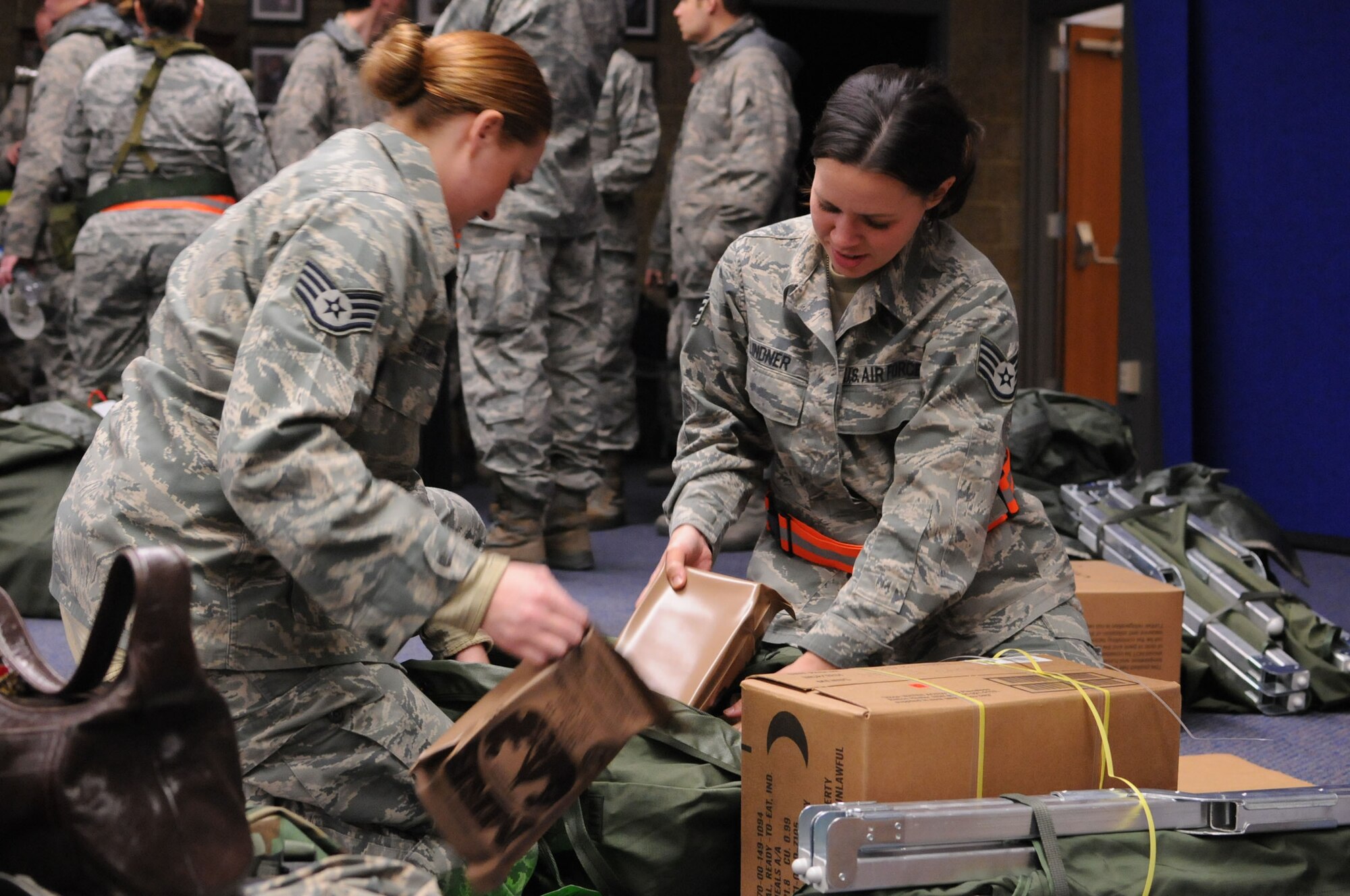 STEWART ANGB  Newburgh, N.Y. --Staff Sgt's. Jennifer Lindner and Amanda Surwillo, 137AS, packing MREs as they and fellow members of the 105th Airlift Wing and 213 Engineering Installation Squadron prepare for deployment as part of the State response to Hurricane Sandy Wednesday morning Oct. 31, 2012. The Airmen are among more than 2,400 Army and Air National Guard Soldiers and Airmen deployed at the order of Governor Andrew M. Cuomo. The Airmen are part of Joint Operations Area 3, Joint Task Force 3 Hurricane relief operations.