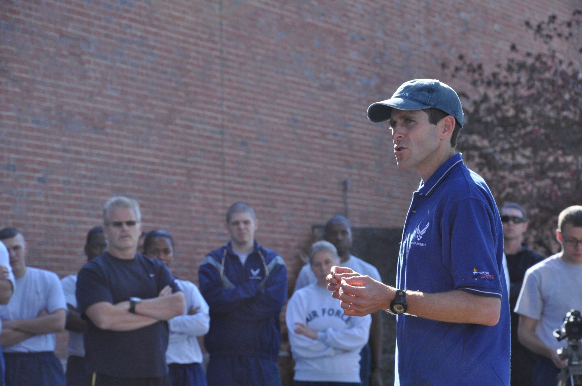 Lt. Col. Mark Cucuzzella, West Virginia University professor of family medicine and two time Air Force Marathon champion explains to the crowd of servicemembers the mechanics of the leg and the benefits of running bare foot at the base theater at Scott Air Force Base, Ill. Oct. 25, 2012. Shoes with heels alter the normal body posture, causing the user to have a more leaned back posture putting more pressure on the joints instead of the muscles.  (U.S. Air Force photo/Airman 1st Class Jake Eckhardt)