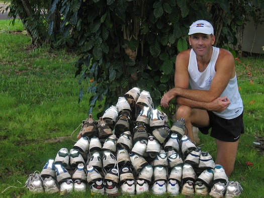 KIRTLAND AFB, N.M. -- Lt. Col. Craig Hess displays the shoes he has worn in marathons. Hess ran 50 marathons before reaching his 50th birthday. (Courtesy photo)