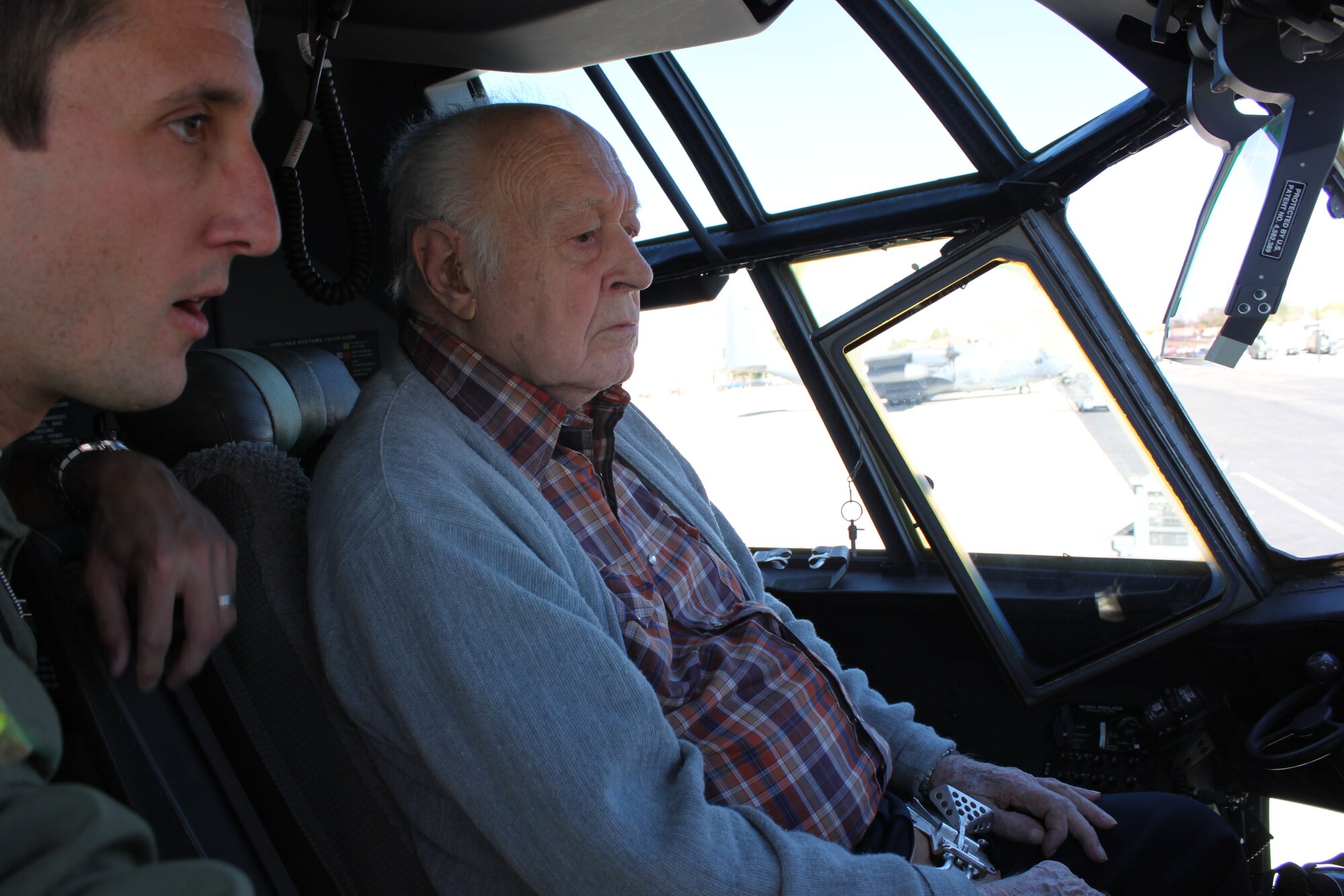 KIRTLAND AFB, N.M. -- Richard Eldridge looks over the cockpit of a C-130J during a tour Oct. 24 as Maj. Tim Paschke, 415th Special Operations Squadron, explains the changes to the aircraft the new model brings. Eldridge is a retired Navy captain who was commissioned in 1943 and spent served for 33 years. He has more than 6,200 flight hours and made 732 carrier landings. He served in World War II, the Korean War and Vietnam. His duties included being a flight instructor, a test pilot for the F-4 Phantom and the Naval Aviation Safety Center director for the Atlantic Fleet. After retiring from the Navy, he formed his own aviation company. (Courtesy photo)