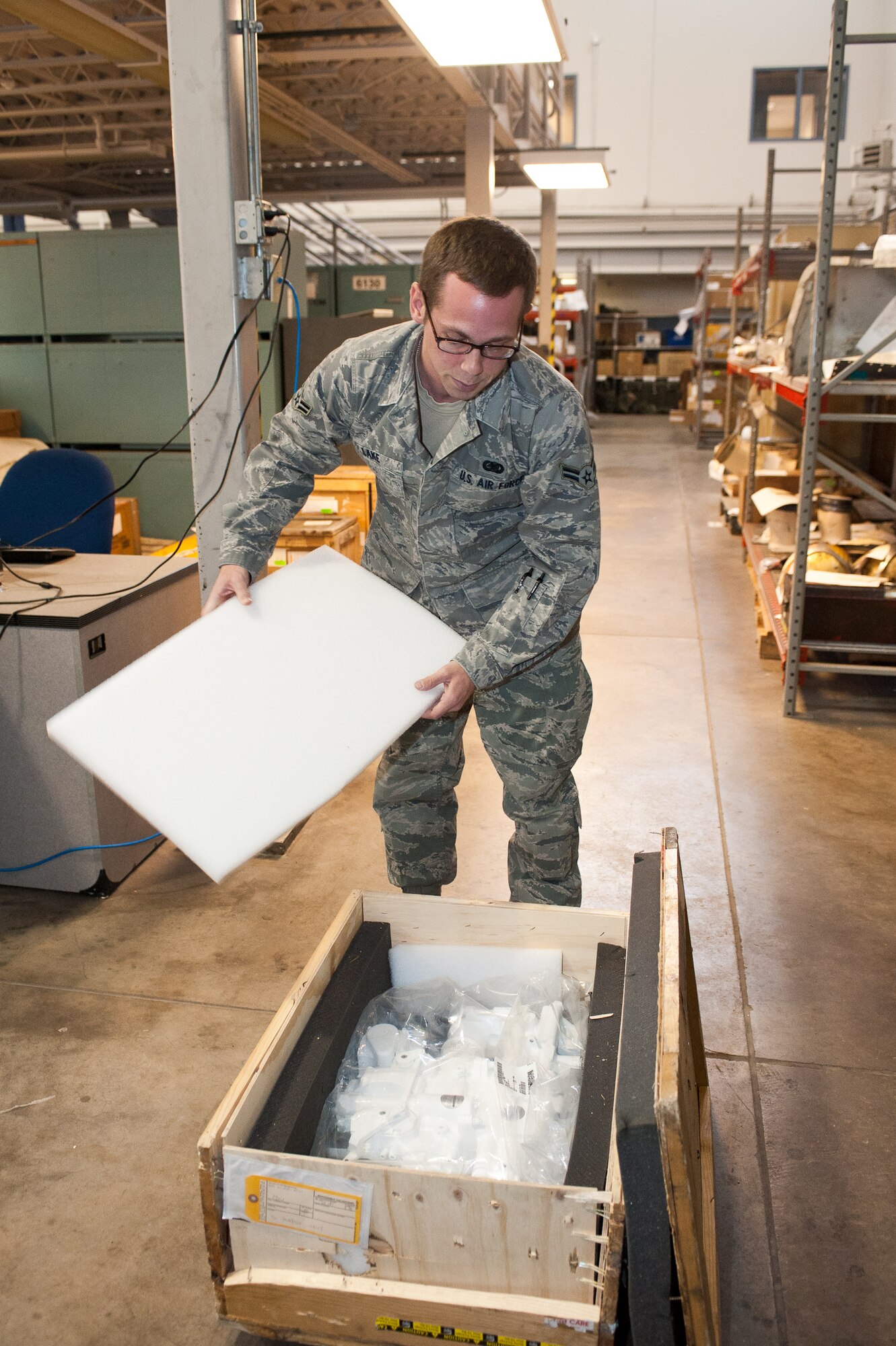 Airman 1st Class Joshua Lake, 28th Aircraft Maintenance Squadron combat oriented supply organization technician, inspects an aircraft part before turning it into the flight service center at Ellsworth Air Force Base, S.D., Oct. 25, 2012. Lake must verify that all the paperwork and items have been correctly packaged prior to shipping. (U.S. Air Force photo by Airman 1st Class Alystria Maurer/Released)
