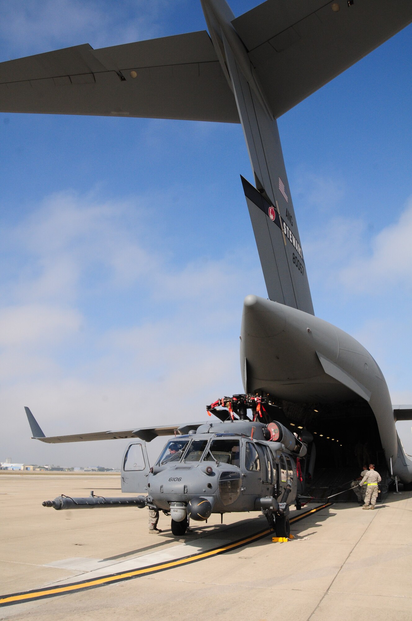 An HH60G Pave Hawk helicopter from the 129th Rescue Squadron is loaded into a C17 Globemaster III at Moffett Federal Airfield, Calif., Oct 29, 2012.  More than 100 California Air National Guardsmen from the 129th Rescue Wing  prepare to mobilize to the East Coast to assist with Hurricane Sandy rescue efforts.  Two MC-130P Combat Shadow aircraft, two HH-60G Pave Hawk rescue helicopters and two Guardian Angel Pararescue teams mobilized to the East Coast to provide life-saving rescue capabilities to those in need in the aftermath of Hurricane Sandy.  (Air National Guard photo by Tech. Sgt. Ray Aquino/RELEASED)