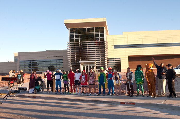 Larry Bridges, 99th Force Support Squadron sports director, hosts a contest for best costume during the Halloween 5K Run at the Warrior Fitness Center Oct. 31, 2012, at Nellis Air Force Base, Nev. Participants ran from the Warrior Fitness Center to the Nellis Golf Course and back. (U.S. Air Force photo by Staff Sgt. Christopher Hubenthal)