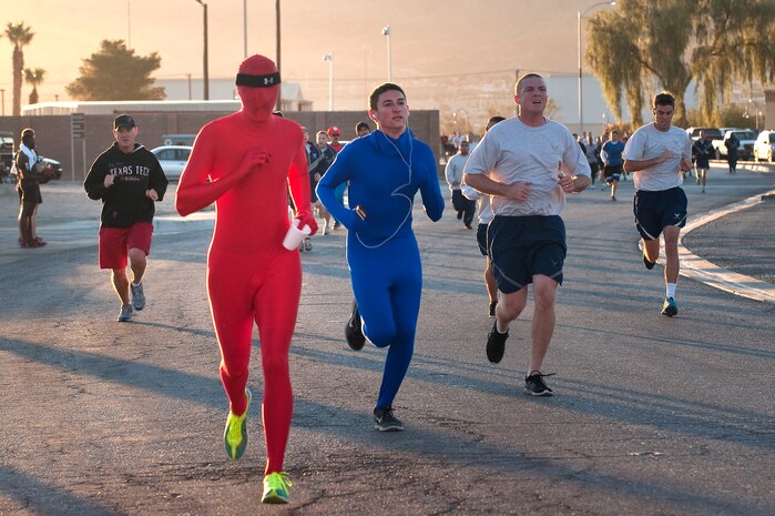 Service members and their families near the finish line during the Halloween 5K Run at the Warrior Fitness Center Oct. 31, 2012, at Nellis Air Force Base, Nev. After completion of the run Airmen and family members voted for the best costume at the event. (U.S. Air Force photo by Staff Sgt. Christopher Hubenthal)