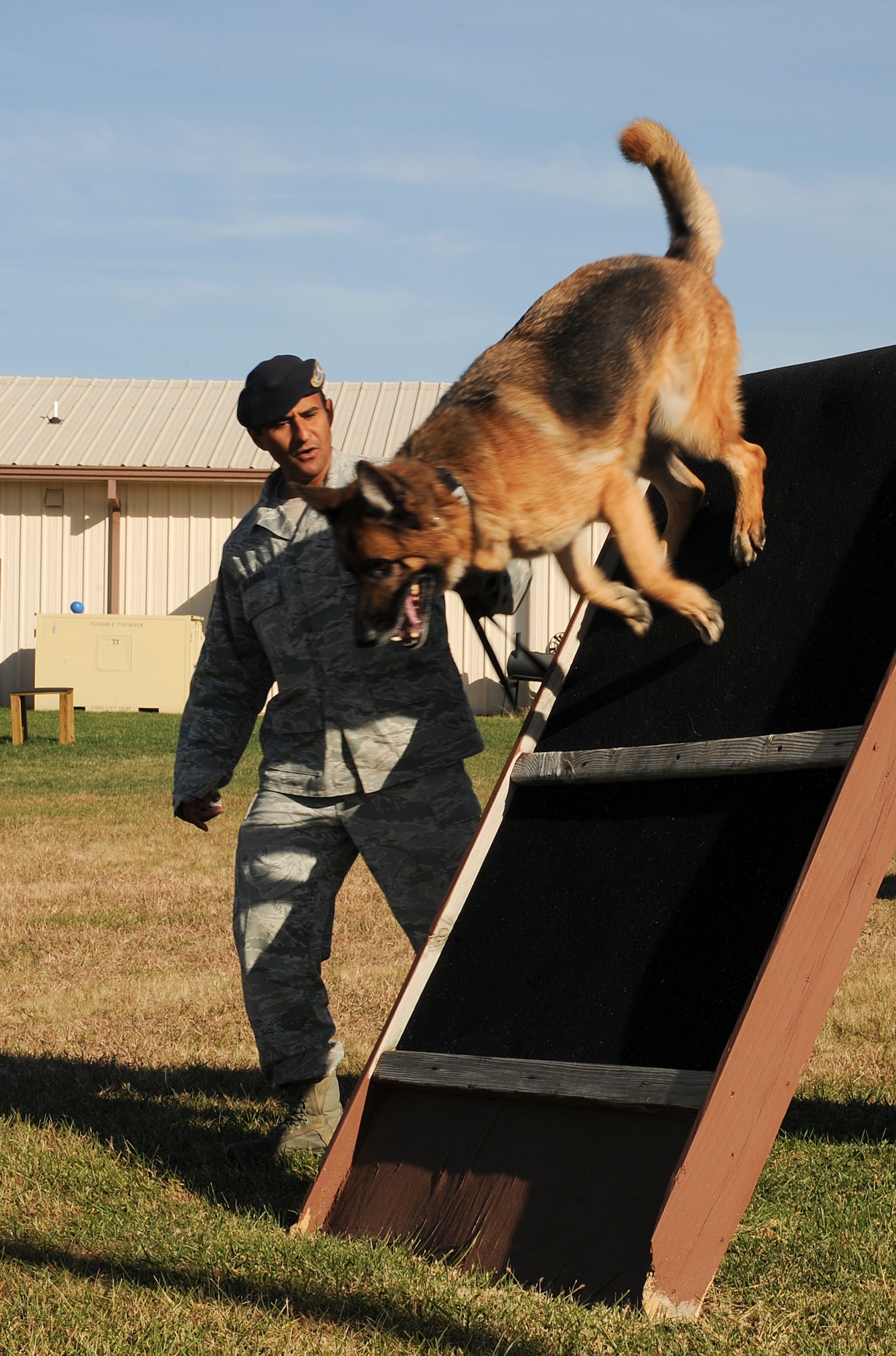 Staff Sgt. Pierre Delgado, 22nd Security Forces Squadron military working dog handler, and Rakker, 22nd SFS military working dog, go through obedience drills Oct. 31, 2012, McConnell Air Force Base, Kan. Obedience drills keep the dogs fit and acclimated to the weather as it gets colder. (U.S. Air Force photo/Airman 1st Class Jose L. Leon)