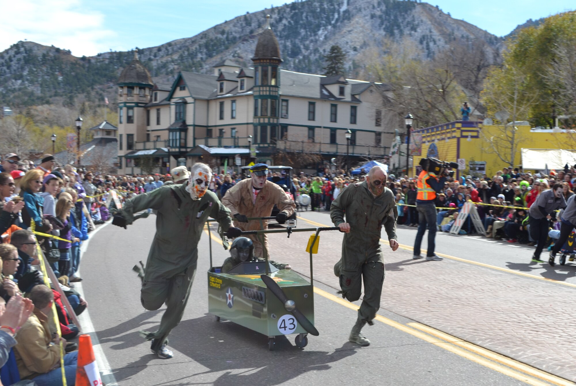 MANITOU SPRINGS, Colo. -- Ghoulish Airmen from the Vosler NCO Academy push their entry in the Emma Crawford coffin race Oct. 27, 2012, in Manitou Springs, Colo. Pushing the coffin were (left to right) Master Sgt. John Hahm, Master Sgt. Todd Badger and Tech. Sgt. Craig Hatcher, and riding in the coffin was Master Sgt. Sharon Lawson. Their entry was inspired by the B-17 that Tech. Sgt. Forrest Vosler, the NCO Academy’s namesake, flew on. Vosler was the second enlisted Airman to ever receive a Medal of Honor. Team Vosler placed seventh out of 50 teams in the race. (U.S. Air Force photo/Chief Master Sgt. Gregory Stone) 