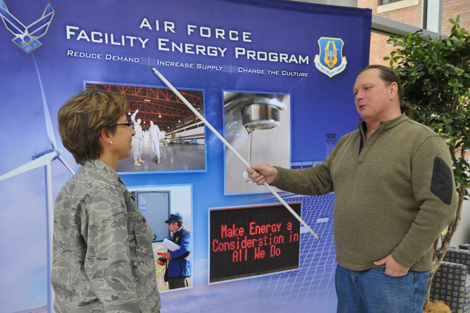 Everett Wilson, 910th Airlift Wing Energy Manager, discusses 910th Airlift Wing energy conservation implementation with Col. Teresa Hams, commander of the 910th Mission Support Group, here Oct. 30. Wilson is holding a state-of-the-art T-5 fluorescent bulb. More than 3,000 of the bulbs have been replaced at the 910th significantly reducing energy costs. (U.S. Air Force photo by Maj. Brent J. Davis)  