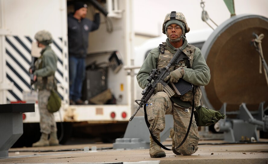 MISSILE COMPLEX, N.D. -- Airman 1st Class Tavarus Roberts, 791st Missile Security Forces Squadron response force leader, guards a missile site as part of a maintenance security escort team, Oct. 23. Site security is a top priority during facility maintenance. (U.S. Air Force photo/Senior Airman Jose L. Hernandez)