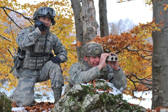 Airmen First Class Aaron Corrales and Travis Lowe, 2nd Air Support Operations Squadron tactical air control party, coordinate a call to A10s from Spangahlem Air Base for air support during the Joint Mission Readiness Exercise in Hohenfels, Germany, Oct. 29, 2012. Main goal of the exercise was to practice integration with the Army and hone skills on force on force land operations. (U.S Air Force photo/Senior Airman Caitlin O’Neil-McKeown)