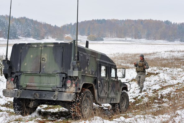 Airman First Class Travis Lowe, 2nd Air Support Operations Squadron tactical air control party, directs a Humvee though a rough patch in the road during the Joint Mission Readiness Exercise in Hohenfels, Germany, Oct. 29, 2012. Main goal of the exercise was to practice integration with the Army and hone skills on force on force land operations. (U.S Air Force photo/Senior Airman Caitlin O’Neil-McKeown)