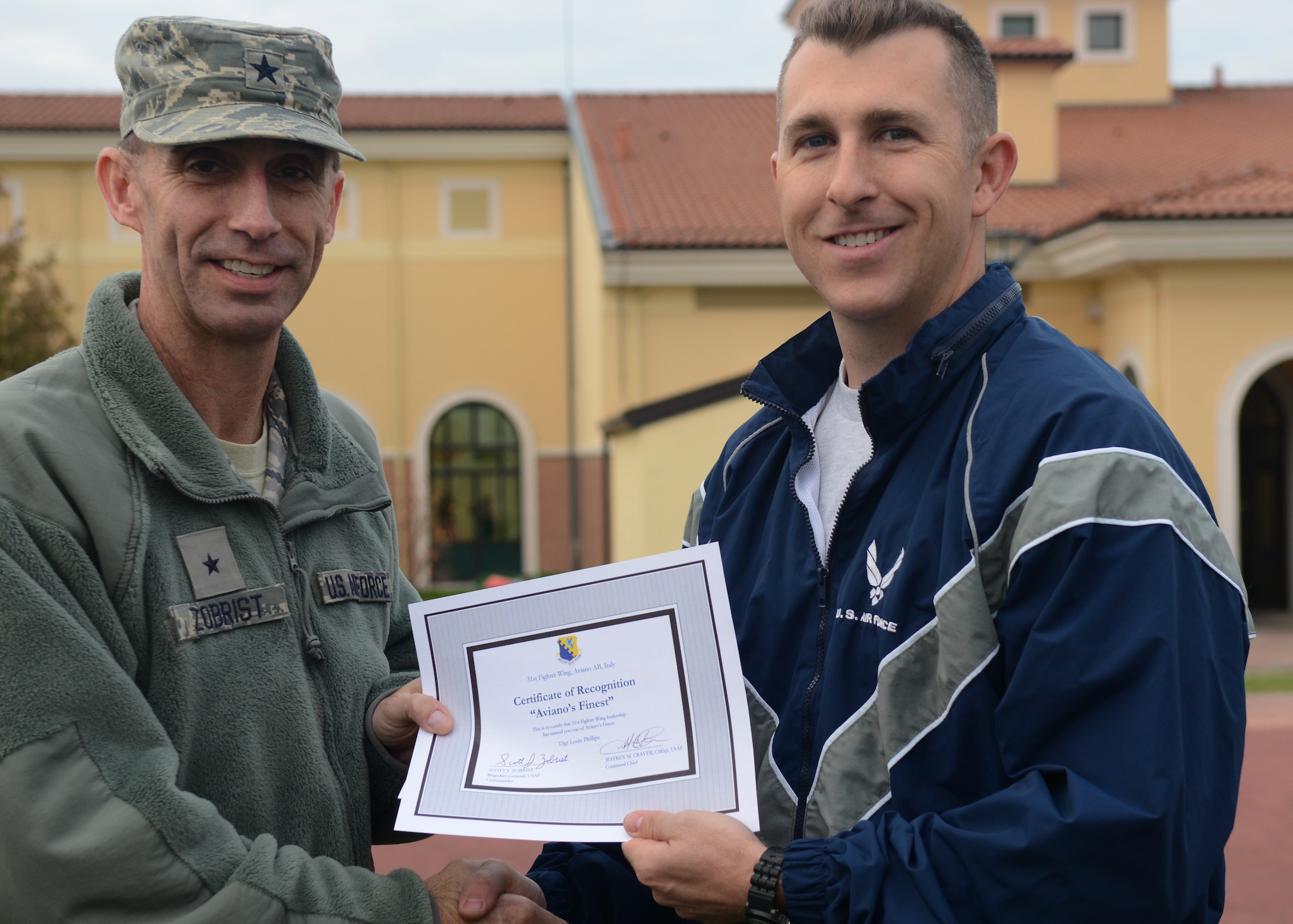 Brig. Gen. Scott J. Zobrist, 31st Fighter Wing commander, congratulates Tech. Sgt. Louis Phillips, 8th Air Support Operations Squadron section chief of logistics, on his selection as one of Aviano’s finest Oct. 31 at Aviano Air Base, Italy. (U.S. Air Force photo/Airman 1st Class Briana Jones)
