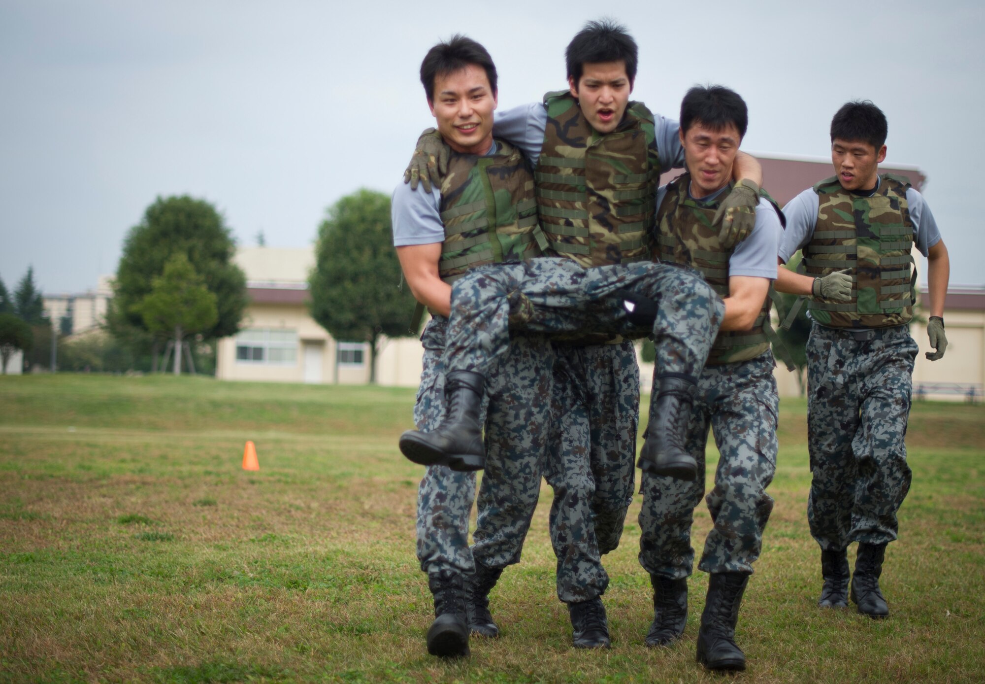 YOKOTA AIR BASE, Japan -- Members from the Japan Air Self-Defense Force perform an injured Airman carry during the 4th Annual Combat Endurance Challenge at Yokota Air Base, Japan, Oct. 27, 2012. Each task simulated strenuous activities military members might face in combat, testing their endurance to see what team had the fiercest warriors. (U.S. Air Force photo by Staff Sgt. Stacy Moless)