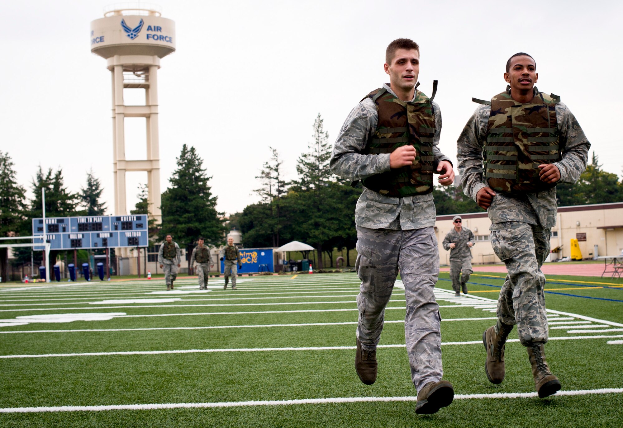 YOKOTA AIR BASE, Japan -- Senior Airman Andrew Biehl and Airman 1st Class Jacob McBride, 730th Air Mobility Squadron, run to the next station after completing the ammo can carry during the 4th Annual Combat Endurance Challenge at Yokota Air Base, Japan, Oct. 27, 2012. The competition consisted of nine events completed in succession. To add to the challenge, contestants were required to wear flack vests throughout the competition hosted by the 730 AMS. (U.S. Air Force photo by Staff Sgt. Stacy Moless)