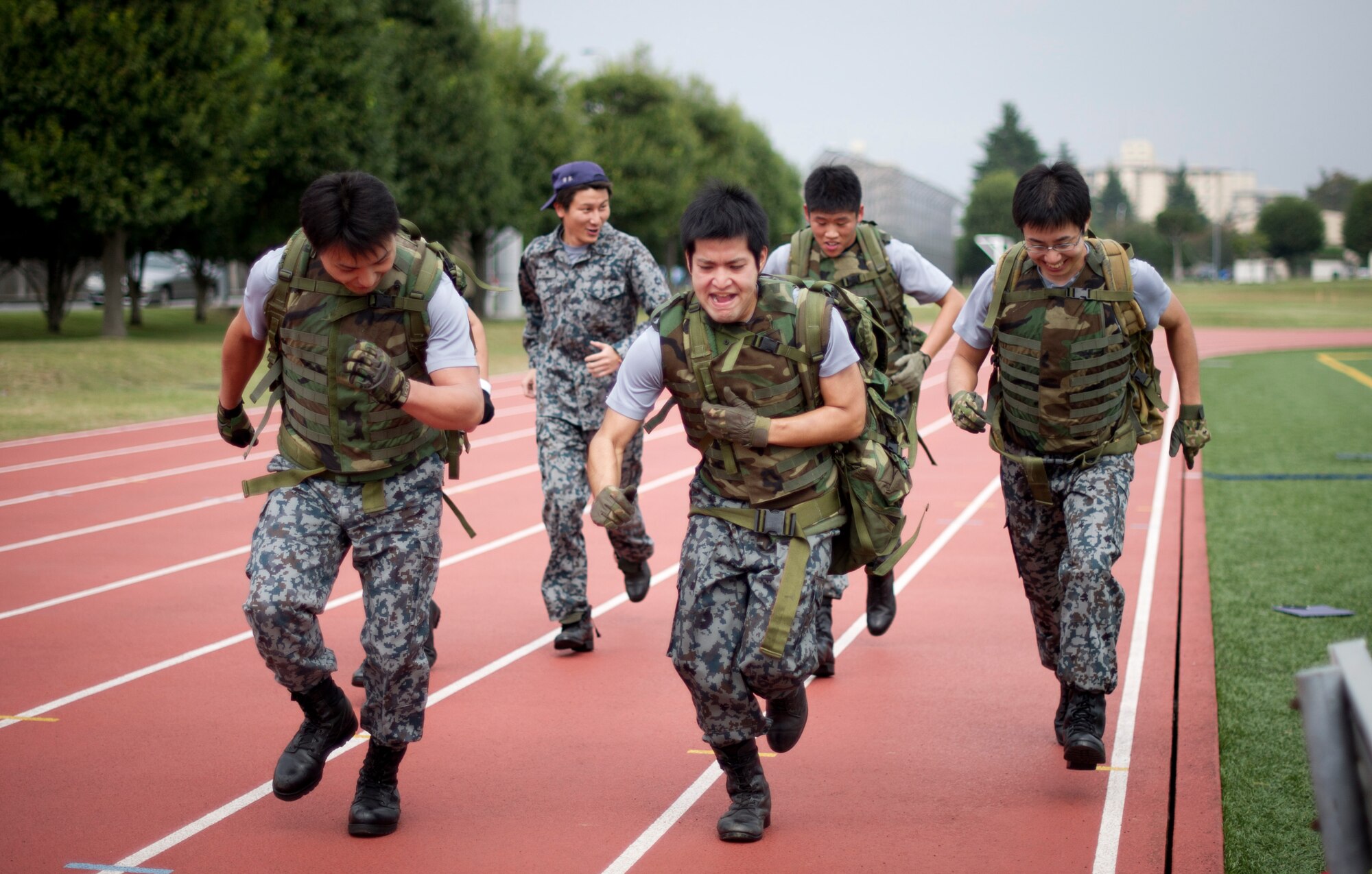 YOKOTA AIR BASE, Japan -- Members from the Japan Air Self-Defense Force complete the last stretch of the mile-long rucksack run during the 4th Annual Combat Endurance Challenge at Yokota Air Base, Japan, Oct. 27, 2012. The challenge gave both U.S. Air Force and JASDF members a chance to not only compete against each other but raise money for the National September 11th Memorial Fund. (U.S. Air Force photo by Staff Sgt. Stacy Moless)