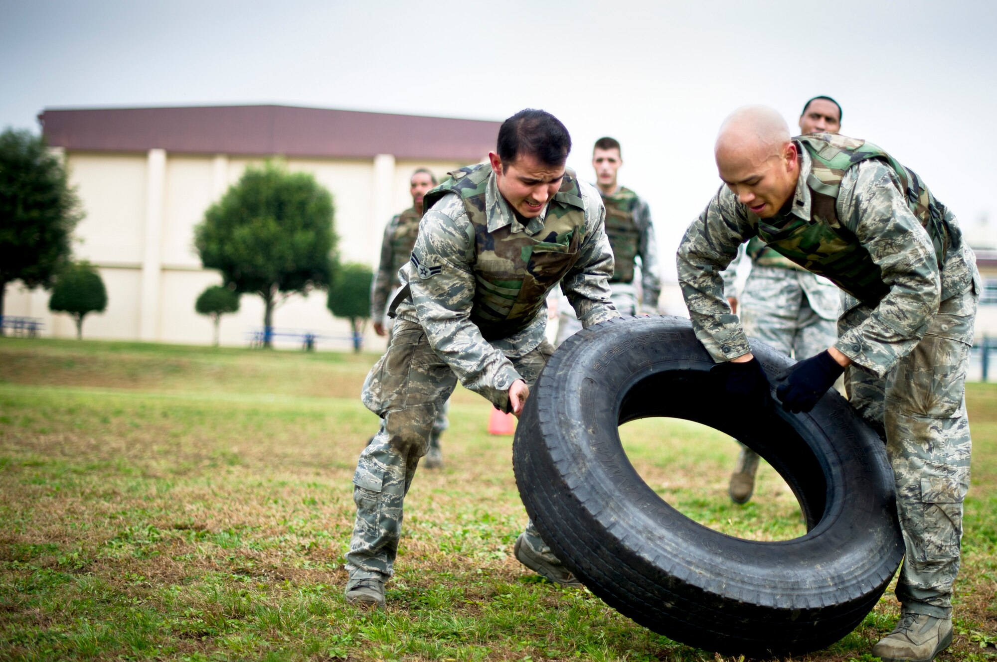 YOKOTA AIR BASE, Japan -- From left to right, Airman 1st Class Grayson Glass, 730th Air Mobility Squadron, and 1st Lieutenant Timothy Truong, 515th Air Mobility Operations Group, flip a tire during the 4th Annual Combat Endurance Challenge at Yokota Air Base, Japan, Oct. 27, 2012. This was one of the physical challenges in the event which benefited the National September 11th Memorial fund. (U.S. Air Force photo by Staff Sgt. Stacy Moless)