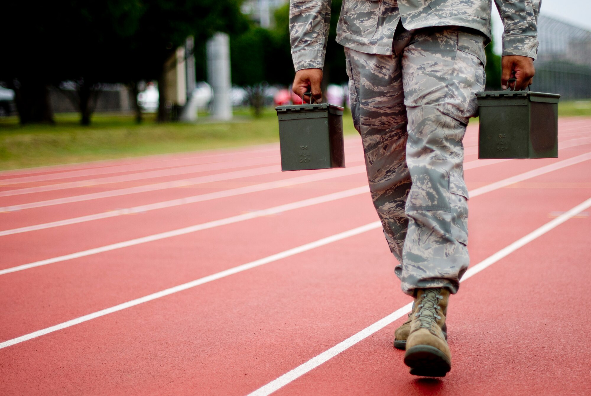 YOKOTA AIR BASE, Japan -- A team member from the 730th Air Mobility Squadron performs the ammunitions can carry during the 4th Annual Combat Endurance Challenge at Yokota Air Base, Japan, Oct. 27, 2012. The obstacle course is comprised of an ammo can carry, tactical drag, humvee push, injured Airman carry, low crawl, litter carry and rucksack run. (U.S. Air Force photo by Staff Sgt. Stacy Moless)