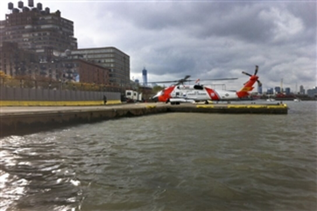An MH-60T Jayhawk helicopter crew prepares to depart New York with Coast Guard Rear Adm. Dan Abelthe, 1st Coast Guard district commander, Oct. 31, 2012. Abel is conducting an overflight of the New York and New Jersey waterways to determine the damage sustained from Hurricane Sandy. The crew is assigned to Coast Guard Air Station Cape Cod, Mass.