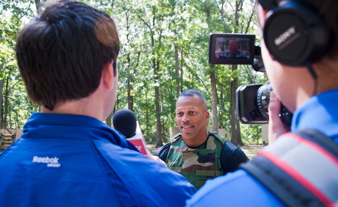 Marine Corps Staff Sgt. Lorris Wilson, reserve company gunnery sergeant, is interviewed by members of the Bridgeport Sound Tigers organization during the team’s visit to the base Sept. 30. About 40 members of the Sound Tigers organization visited the base as part of a team-building exercise. The Sound Tigers is a minor league affiliate of the National Hockey League’s New York Islanders. (U.S. Air Force photo by Staff Sgt. David Carbajal/Released)
