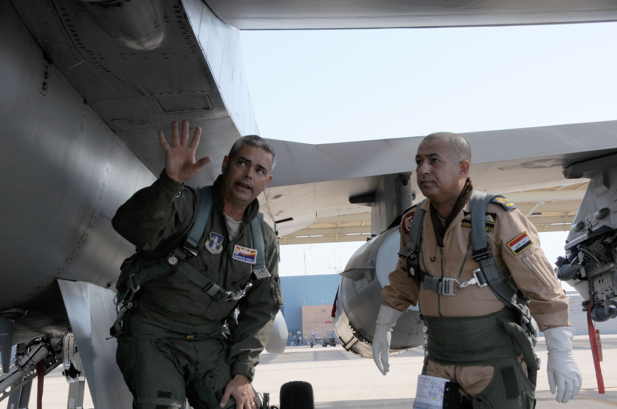 Col. Andrew MacDonald, 162nd Operations Group commander, shows Iraqi Air Force Brig. Gen. Abdulhussein Lafta Ali Ali how to pre-flight an F-16D Fighting Falcon before an orientation flight at Tucson International Airport Aug. 30. Abdulhussein, with a delegation of senior Iraqi officers, visited the international F-16 training wing where Iraqi pilots are learning to fly the multirole fighter. (U.S. Air Force photo/Maj. Gabe Johnson)