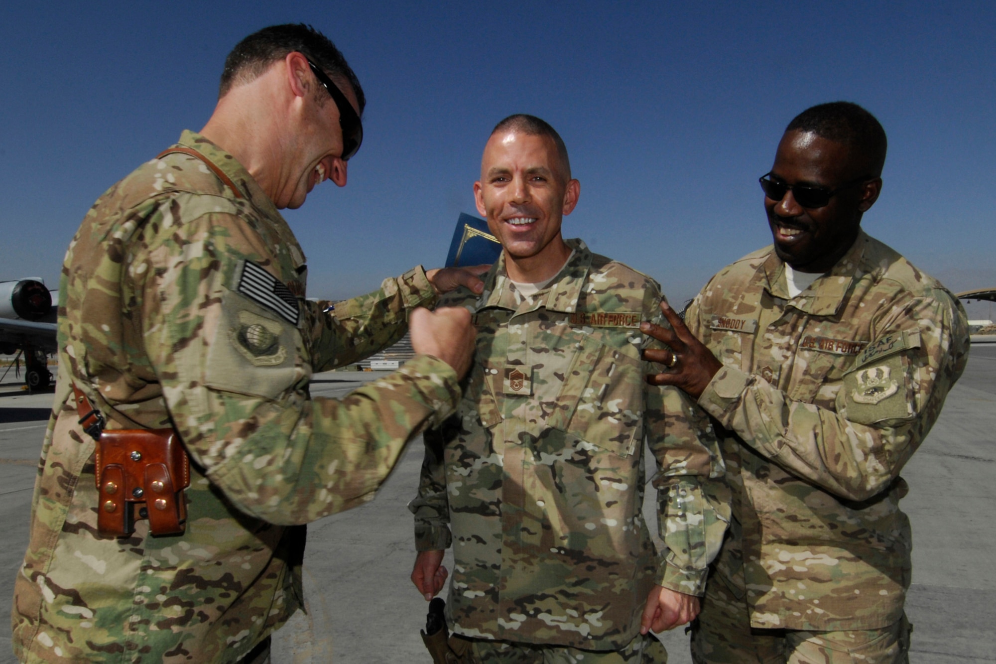 Brig. Gen. Joseph Guastella, 455th Air Expeditionary Wing commander (left), and CMSgt Marcus Snoddy, 455 AEW command chief (right), promote SMSgt Bruce Kimball, 455th Expeditionary Maintenance Squadron First Sergeant, to CMSgt at Bagram Airfield, Afghanistan, Aug. 31, 2012. Kimball, from Bridgton, Maine, has been at Bagram for five months and his home station is Nellis Air Force Base, Nevada. (U.S. Air Force photo/SSgt Jeff Nevison)