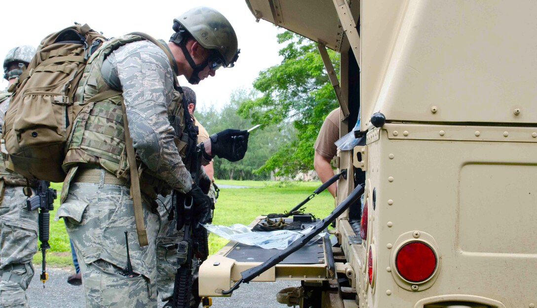 ANDERSEN SOUTH, Guam—Staff Sgt. Josef Miller, 36th Civil Engineer Squadron explosive ordnance disposal flight team lead, documents information on a suspect during Tri-Crab 2012. Tri-Crab is a combined engagement that focuses on strengthening relationships within the Asia-Pacific region through training and information exchanges, to enhance EOD interoperability. (U.S. Air Force photo by Senior Airman Benjamin Wiseman/Released)