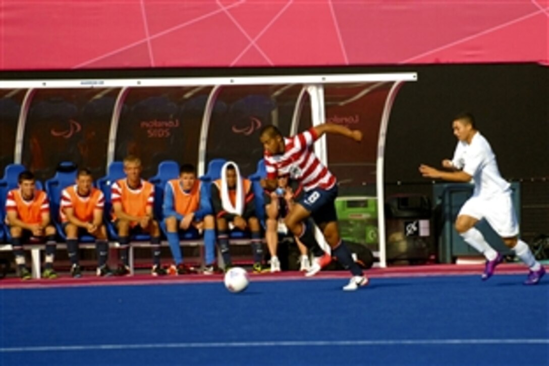 U.S. Marine Corps Cpl. Rene Renteria, a forward for the 2012 U.S. Paralympic Soccer Team, accelerates after stealing the soccer ball from a Brazil player during a soccer match at London's Riverbank Arena, Sept. 3, 2012.