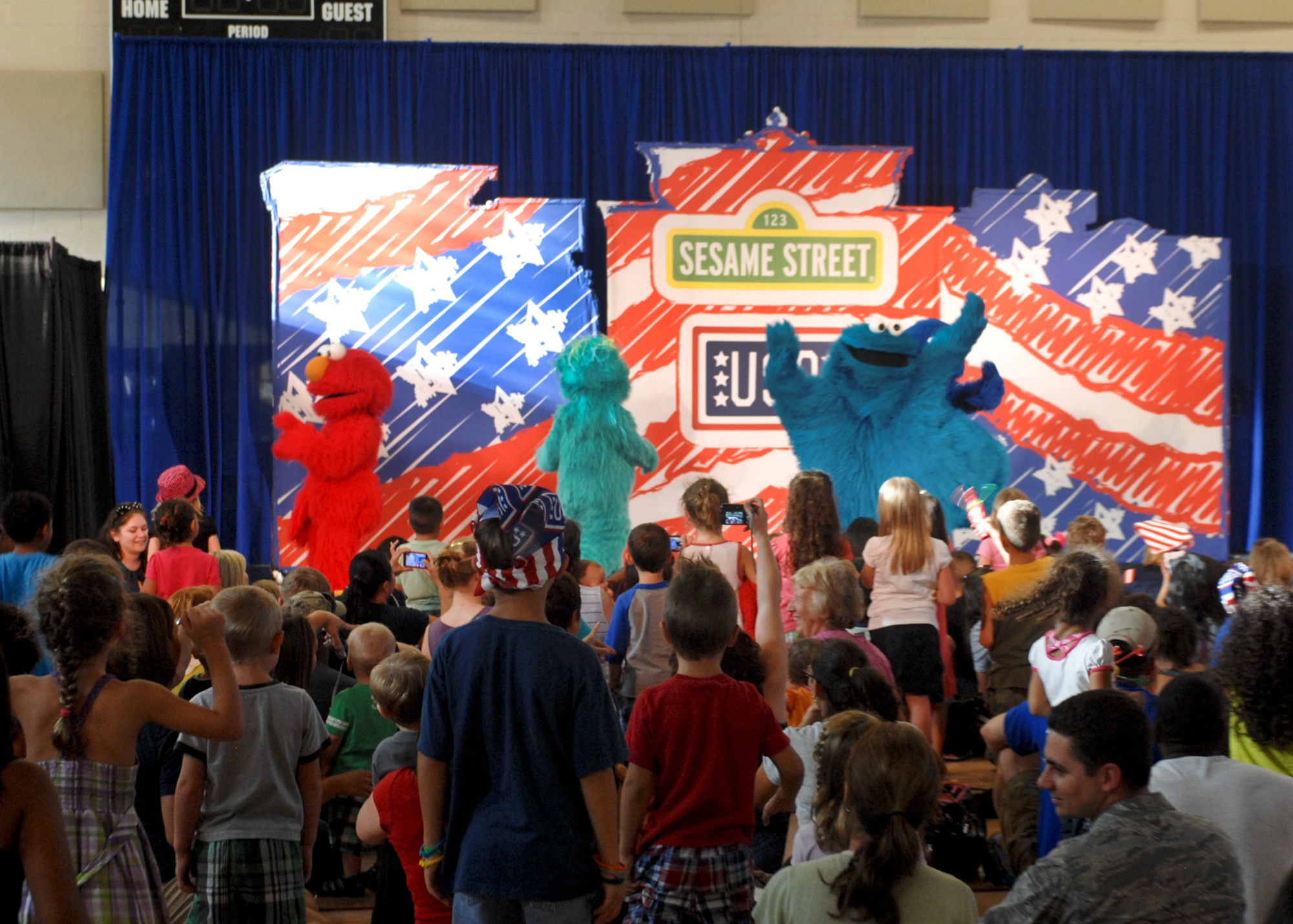 Sesame Street cast members perform for Airmen and their families during the Sesame Street/USO Experience for Military Families show Aug. 28, 2012 at Nellis AFB, Nev. The show was designed to help military families cope with issues like moving. (U.S. Air Force photo by Senior Airman Jack Sanders)