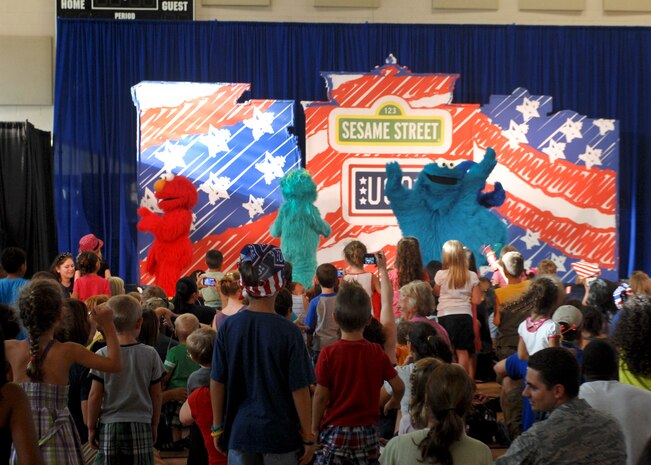 Sesame Street cast members perform for Airmen and their families during the Sesame Street/USO Experience for Military Families show Aug. 28, 2012 at Nellis AFB, Nev. The show was designed to help military families cope with issues like moving. (U.S. Air Force photo by Senior Airman Jack Sanders)
