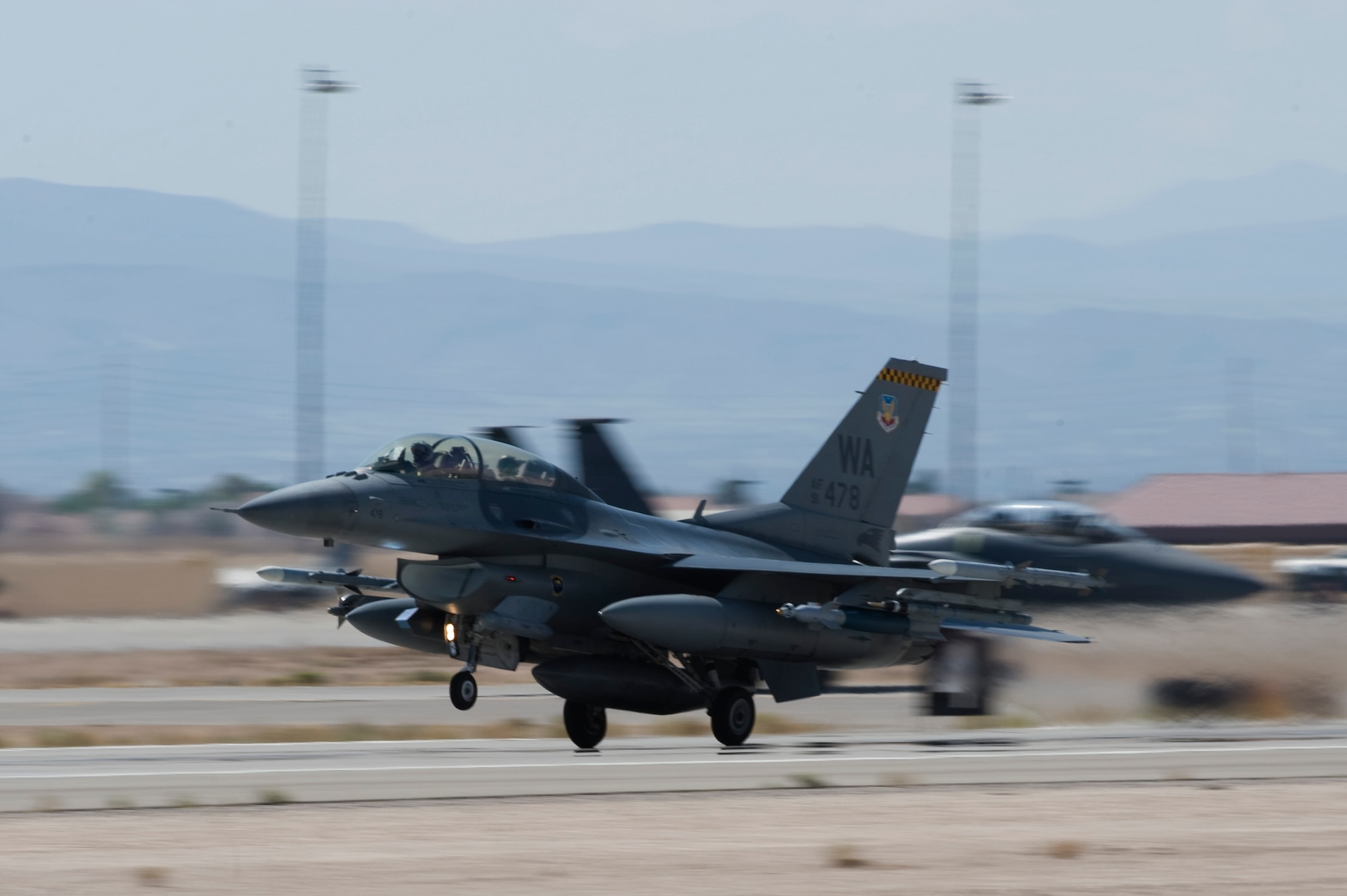 A U.S. Air Force F-16 Fighting Falcon takes off Sept. 4, 2012, at Nellis Air Force Base, Nev. Airmen in the control tower observe weather conditions and assist aircraft during periods of bad weather with the use of radar, instrument landing systems, and various types of airfield lighting. (U.S. Air Force photo by Airman 1st Class Christopher Tam)