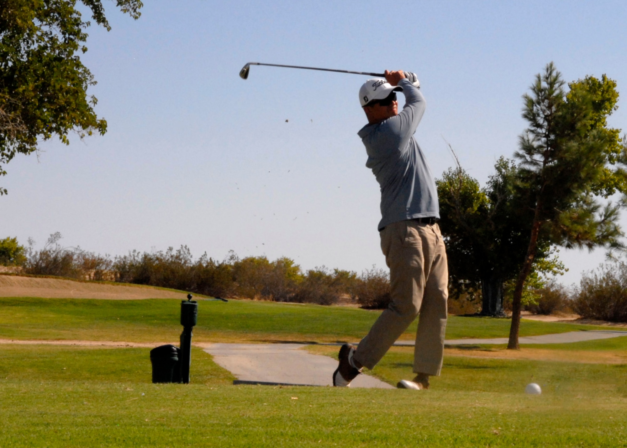 Master Sgt. John Phillips, 412th Aircraft Maintenance Squadron tees off at the 65th Air Force Ball Golf Tournament Aug. 30 at Muroc Lake Golf Course. The tournament will offset event costs and was the largest fundraising event. (Air Force Photo by Laura Mowry)