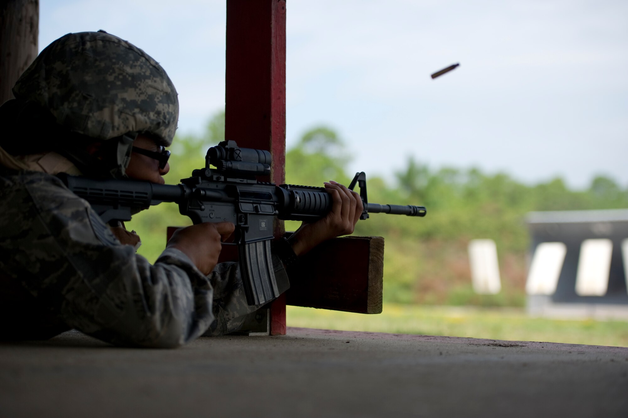 Tech. Sgt. Daisha Oliver, an NCO-in-charge at 1st Special Operations Maintenance Squadron, fires an M-4 during a weapon qualifications test at the firing range on Hurlburt Field, Fla., Aug. 23, 2012.  The type of weapon a person trains on depends on their unit type codes.  (U.S. Air Force Photo/Airman 1st Class Naomi M. Griego)