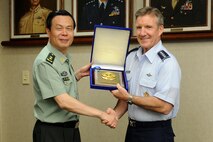 Lt. Gen. Cai Yingting, Deputy Chief of the General Staff of the Chinese People's Liberation Army, presents Gen. Herbert J. “Hawk” Carlisle, Pacific Air Forces commander, with a souvenir gift at the DePonte Suite, Headquarters PACAF, Joint Base Pearl Harbor-Hickam, Hawaii, Aug. 27, 2012. Cai visited Hawaii to discuss issues of mutual interest with senior military and defense leaders. (U.S. Air Force Photo/Tech. Sgt. Jerome S. Tayborn)