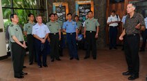 Charles Nicholls, Pacific Air Forces senior historian, gives a guided tour to Lt. Gen. Cai Yingting, Deputy Chief of the General Staff of the Chinese People's Liberation Army, members of his delegation and Gen. Herbert J. “Hawk” Carlisle, PACAF commander, at the Courtyard of Heroes, Headquarters PACAF, Joint Base Pearl Harbor-Hickam, Hawaii, Aug. 27, 2012. Cai and his delegation visited Hawaii to discuss issues of mutual interest with senior military and defense leaders. (U.S. Air Force Photo/Tech. Sgt. Jerome S. Tayborn)