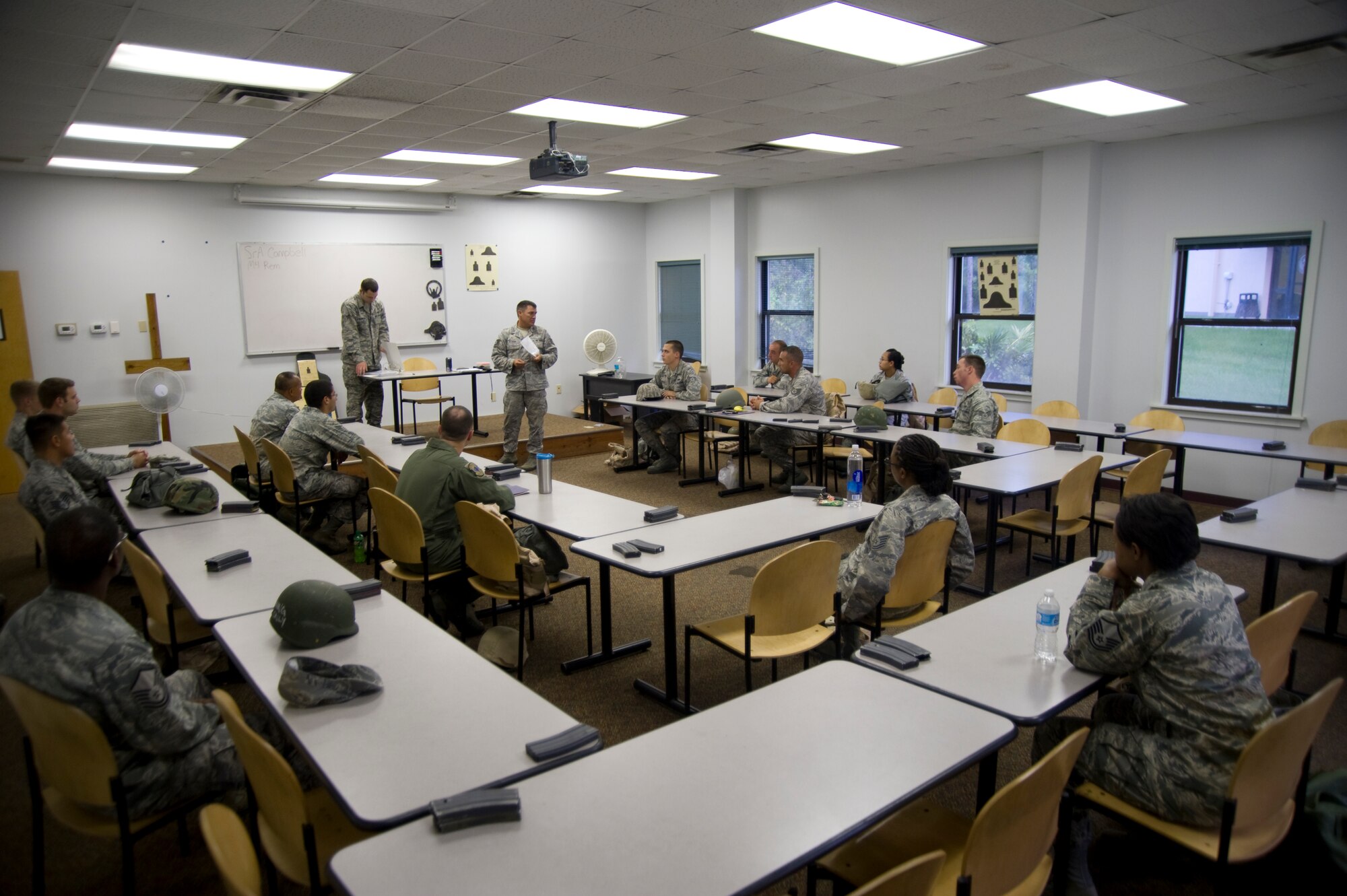 U.S. Air Force Airmen listen to an instructor during a Combat Arms Training and Maintenance course on Hurlburt Field, Fla., Aug. 24, 2012.  CATM instructors train Airmen on various weapons such as pistols, shotguns, grenade launchers, submachine guns and rifles. (U.S. Air Force Photo/Airman 1st Class Naomi M. Griego)