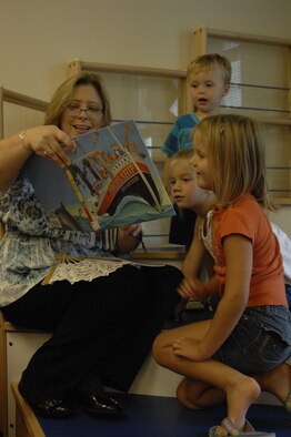 Marie Stanley, the children's program coordinator for the base library, reads “The Circus Ship” to children at Shaw Air Force Base, S.C., Aug. 29, 2012. Stanley also read “Clifford at the Circus” to them before they created paper puppets. Every week, volunteers read to the children and hold an arts and crafts session from 11 a.m. to 12 p.m. and from 1 to 2 p.m. (U.S. Air Force photo by Airman 1st Class Krystal M. Jeffers/Released)