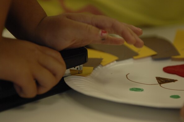 Children of servicemembers create paper lion puppets at the Shaw Air Force Base, S.C., library, Aug. 29, 2012. The crafts were part of a program that the McElveen Library holds every Tuesday from 11 a.m. to 12 p.m. and from 1 to 2 p.m., and includes two stories that are read to the children. Next week, Terra Zeigler, a children’s book author, is scheduled to read to the children. (U.S. Air Force photo by Airman 1st Class Krystal M. Jeffers/Released)